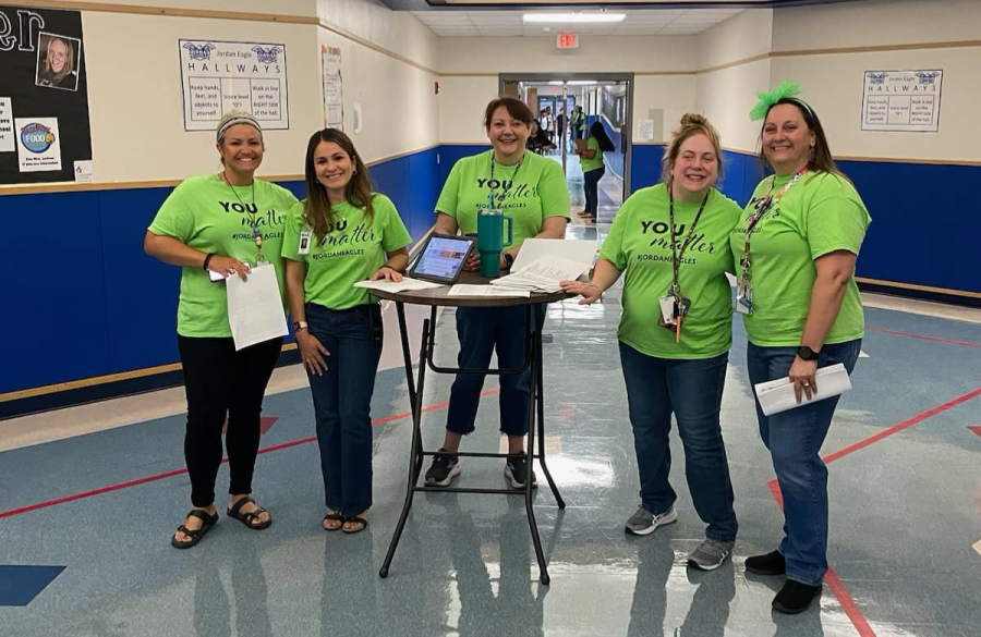 teachers posing together in the hallway