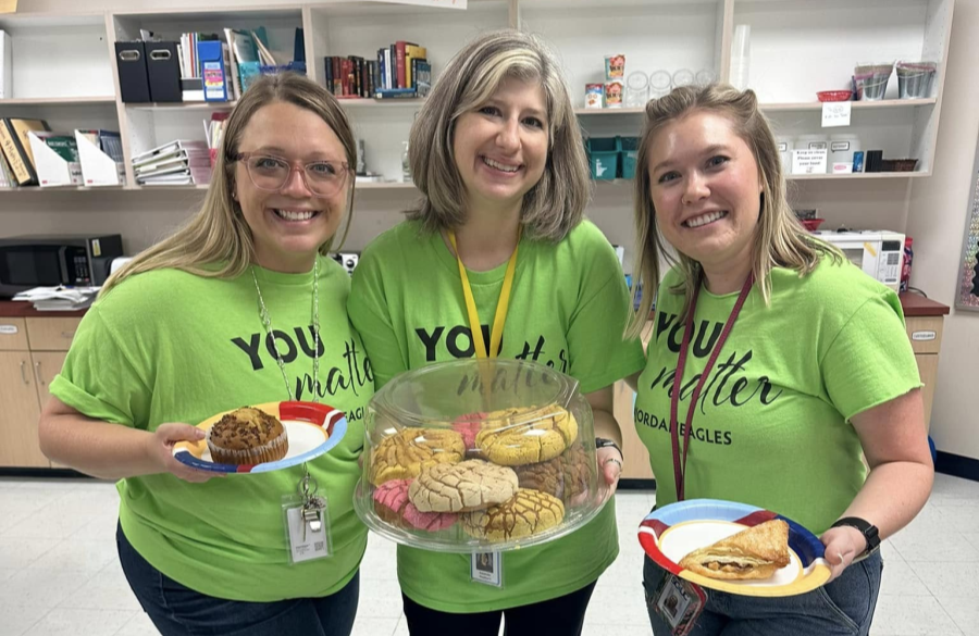 teachers posing together holding sweet treats