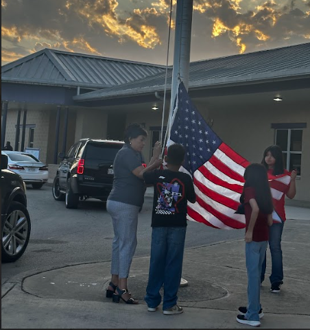 students putting up the flag