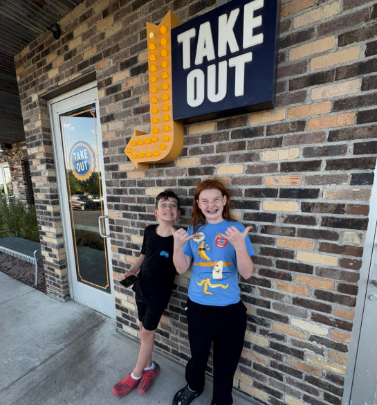 Two students standing outside Willie's