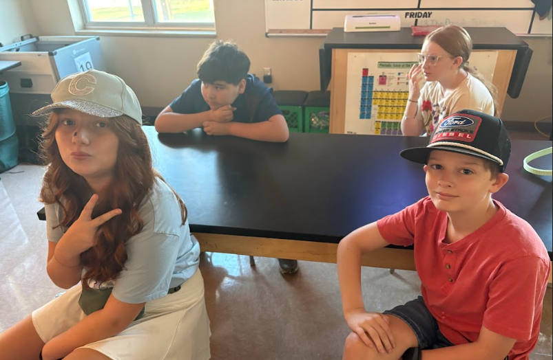 6th grade students posing in hats