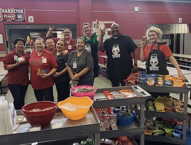 admin handing out snacks to cafeteria workers