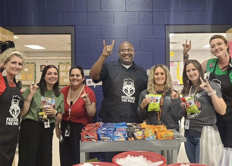 admin handing out snacks to teachers