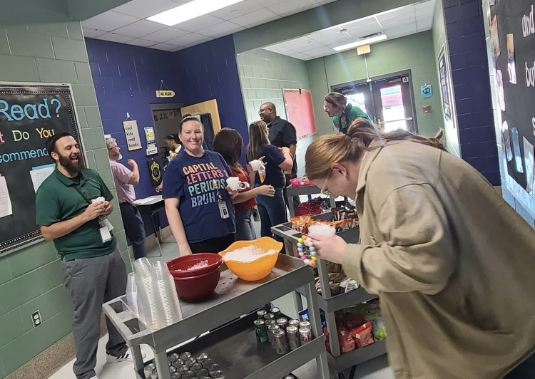 teacher is picking out snacks from the cart
