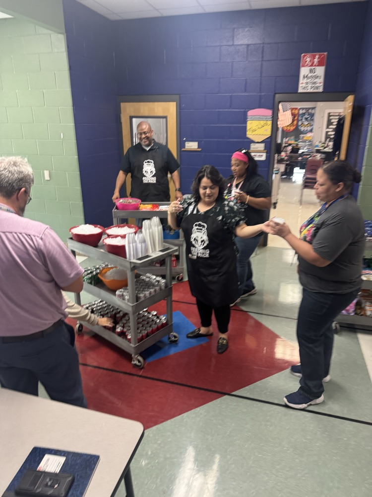 teacher is picking out snacks from the cart