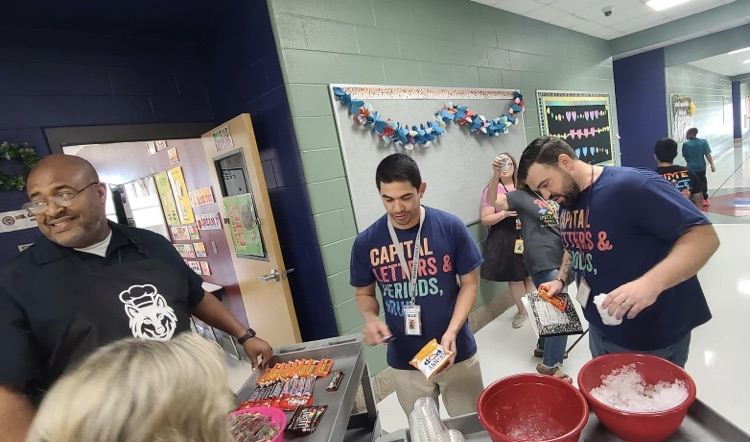 Teachers picking up snacks from the cart