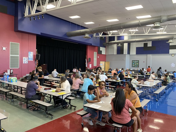 grandparents playing games with Husky students in the cafeteria