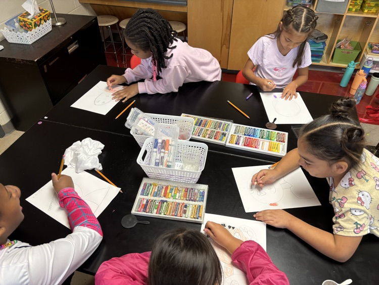 students creating self portraits in art class