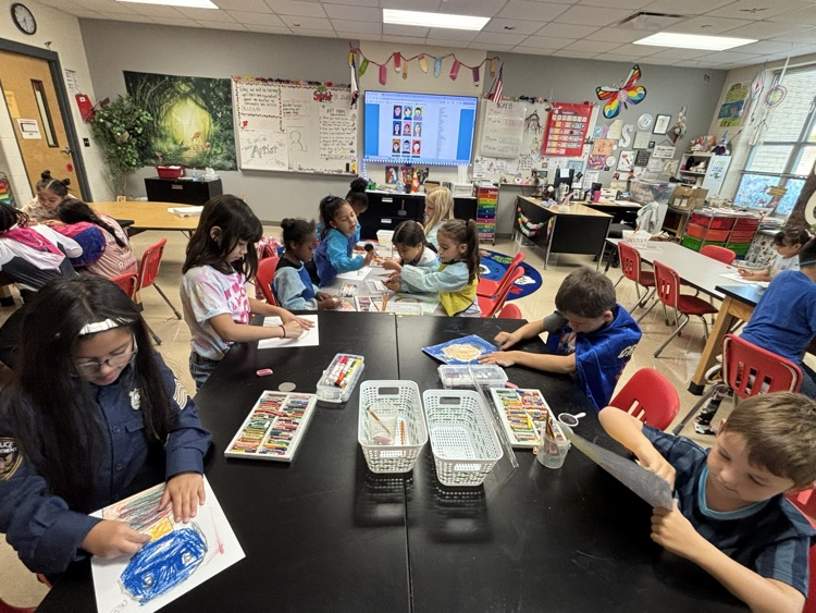 students creating self portraits in art class