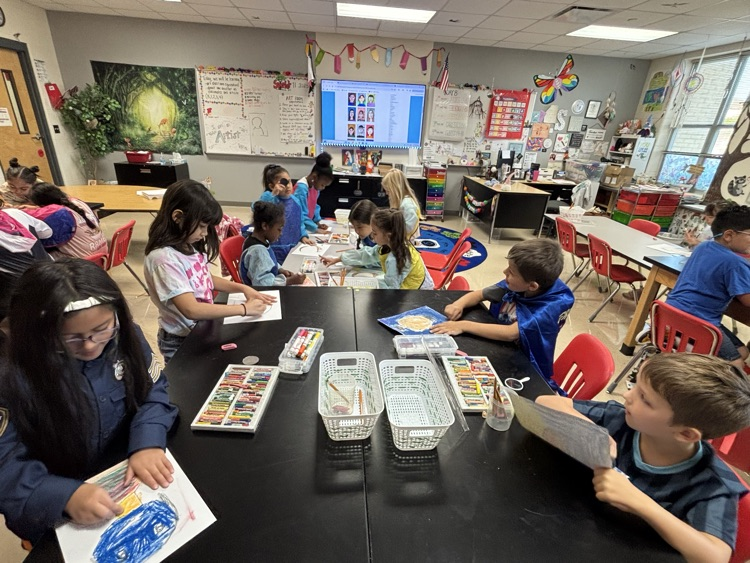 students creating self portraits in art class
