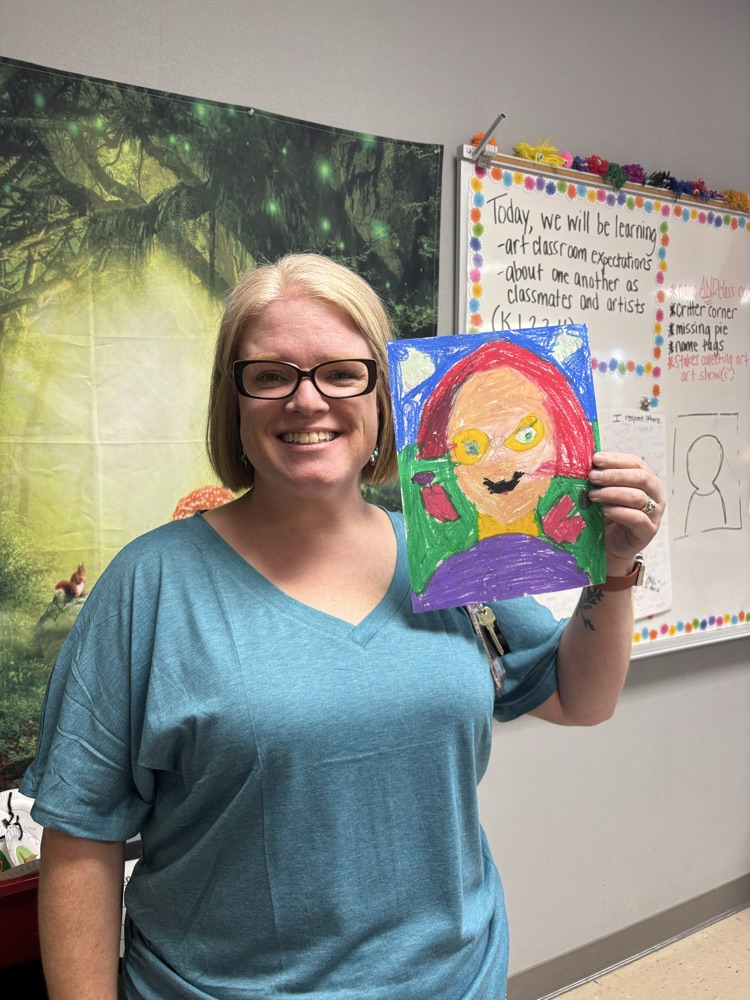 teacher with self portrait drawing