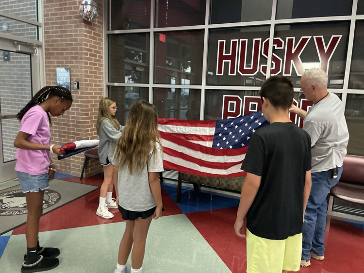 huskies folding American flag