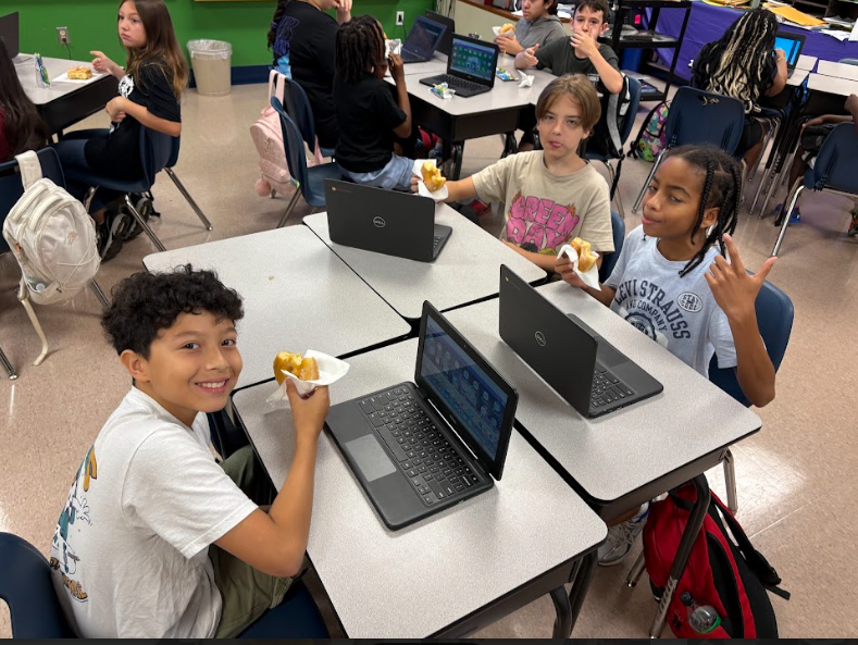 6th graders eating donuts