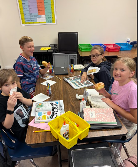 5th graders enjoying their donuts