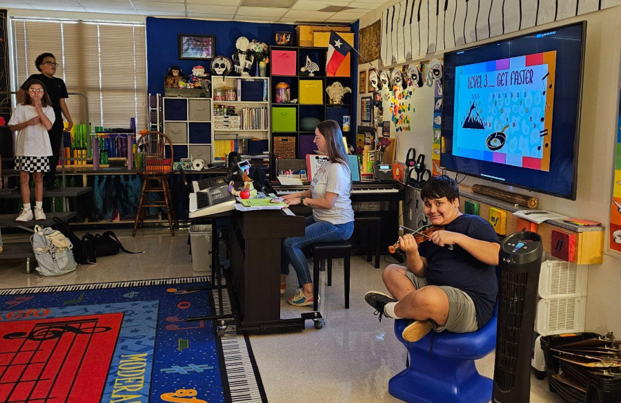 picture of a student playing his instrument in class