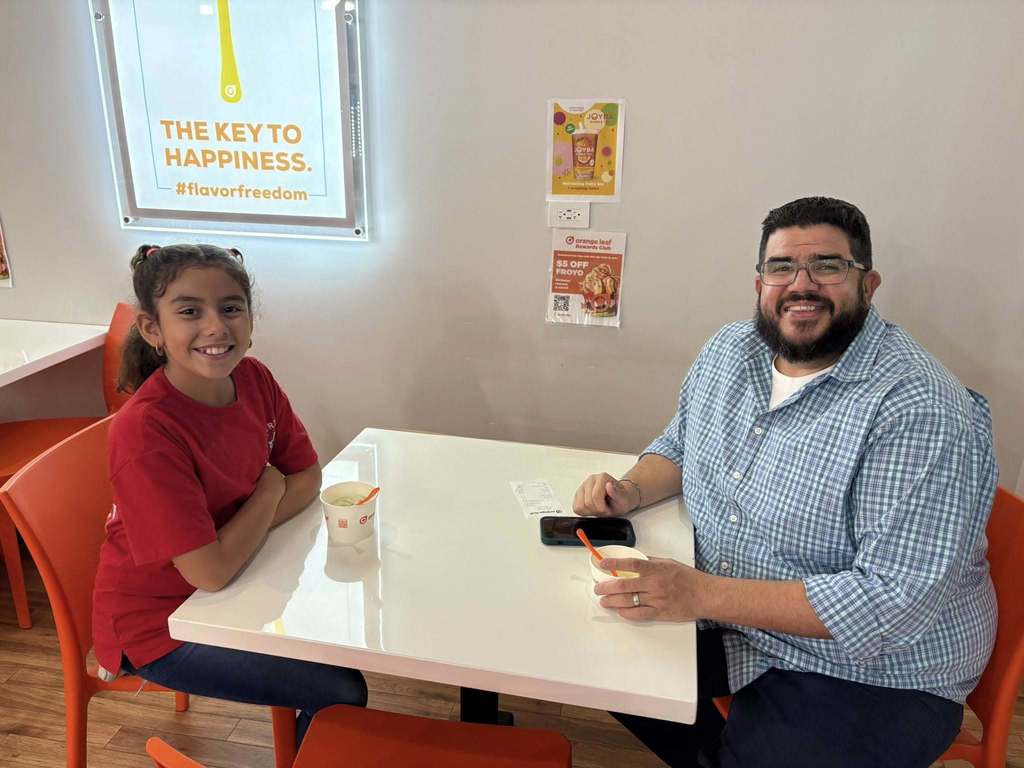 Girl and father eating yogurt