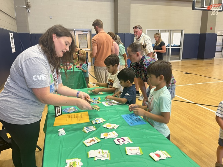 teacher showing students how to play a game