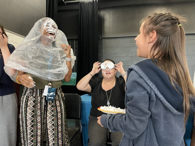 teacher with pain in the face, laughing with student