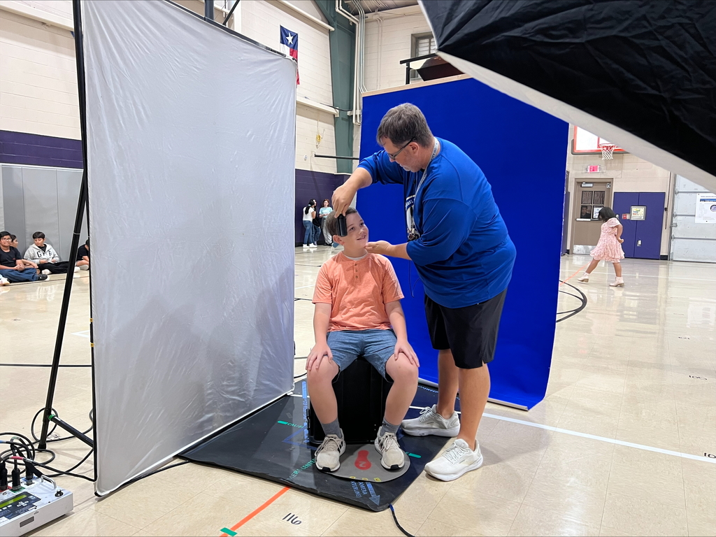 Coach Ryan fixing his 6th grade son's hair for picture day.