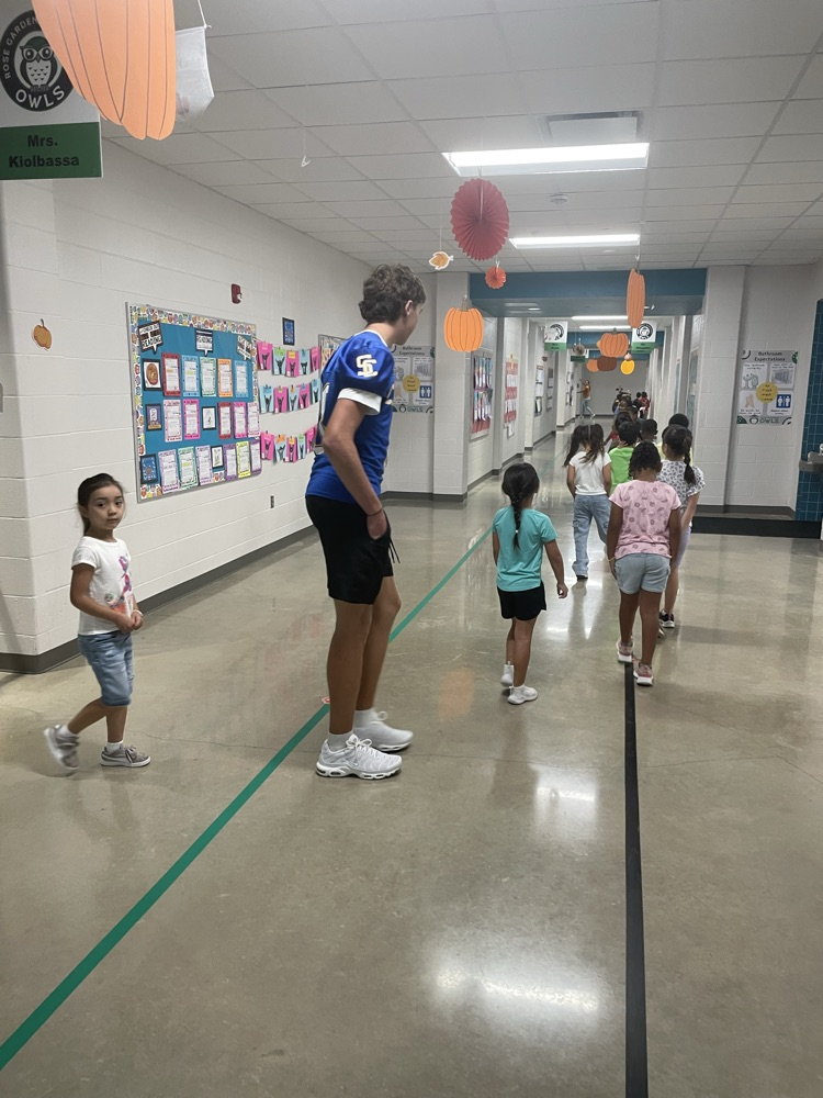 Buffs greeting kids in the hallways