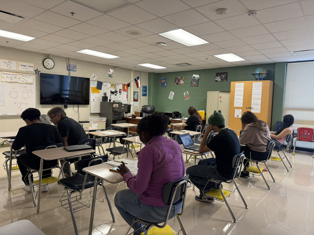 students working on math and teacher teaching student
