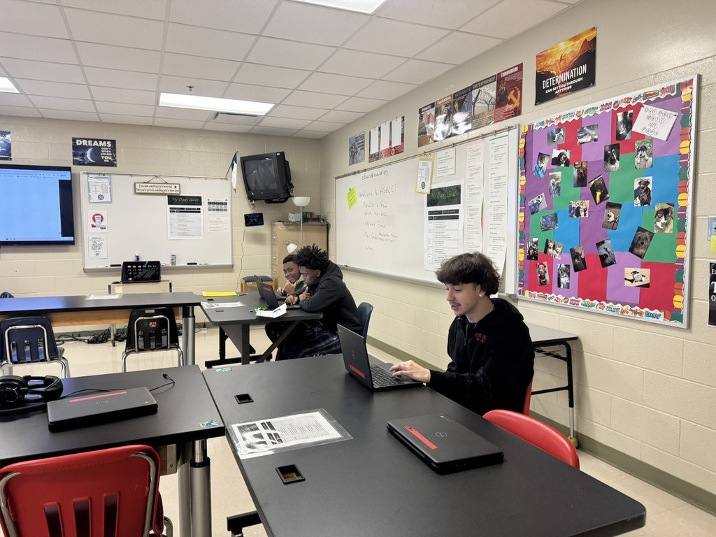 three students working on computers