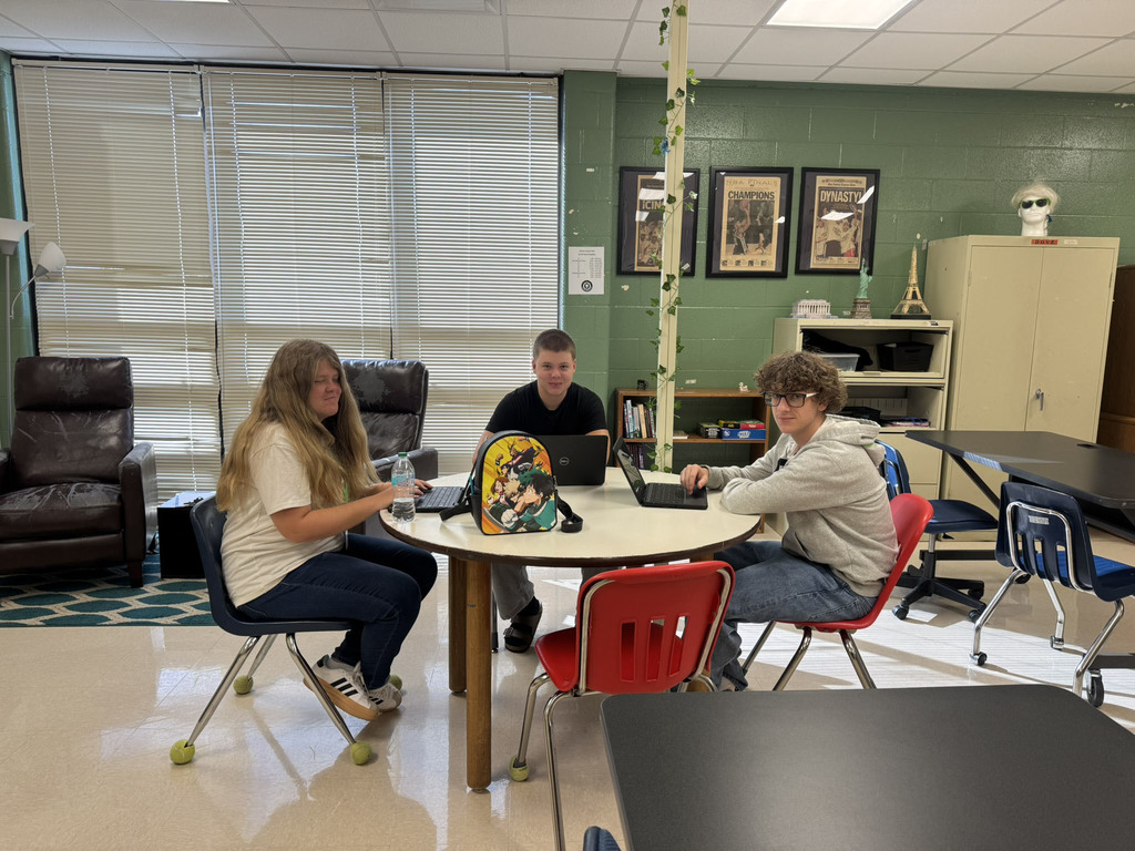three students working together in a group