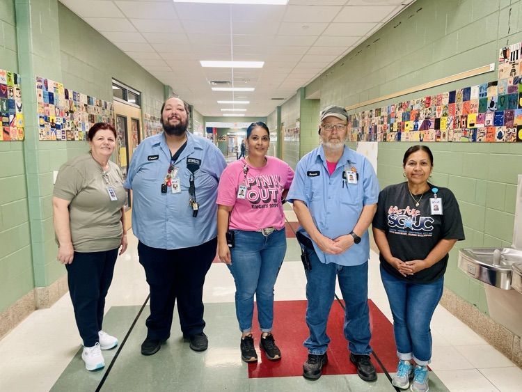 custodians posing in the hallway
