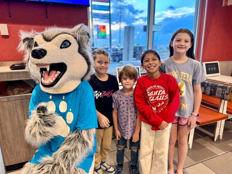 Husky mascot with students at McDonald’s