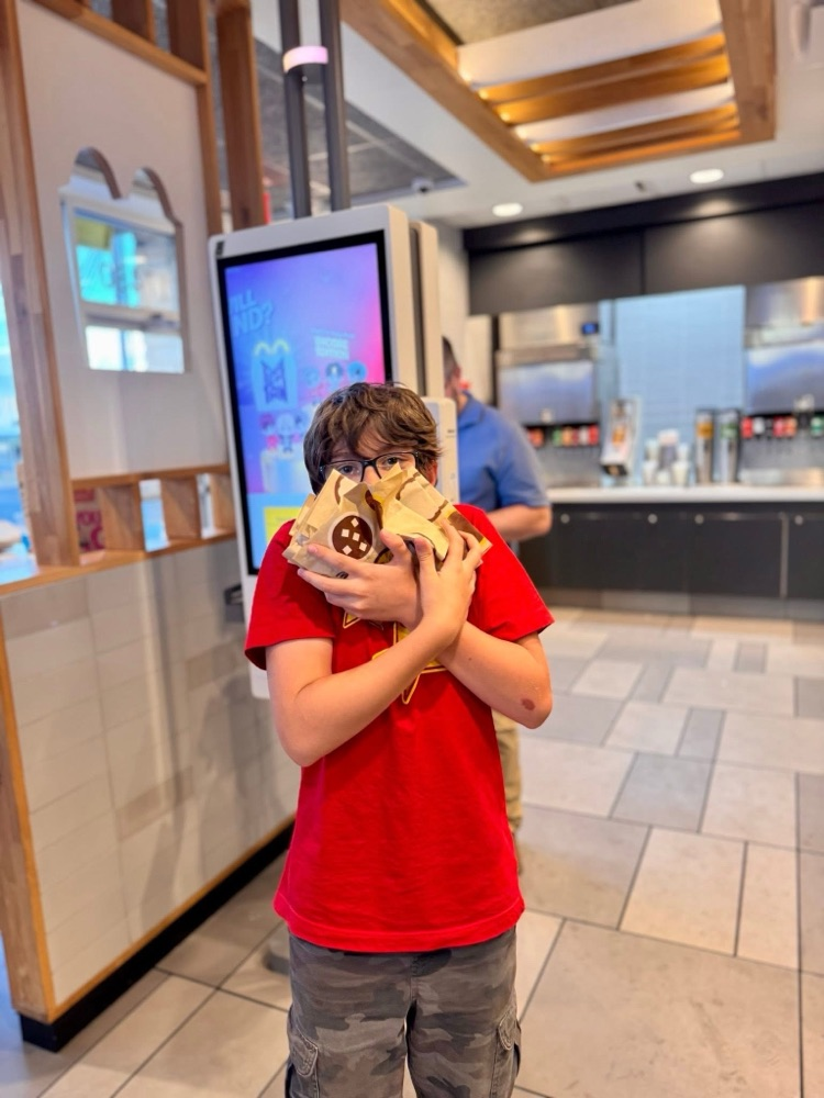 Student holding a bunch of cookies that they bought at McDonald’s