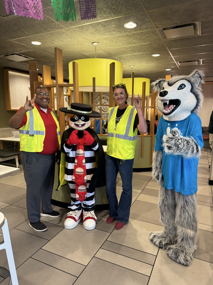 Admin posing with the hamburger and husky mascot