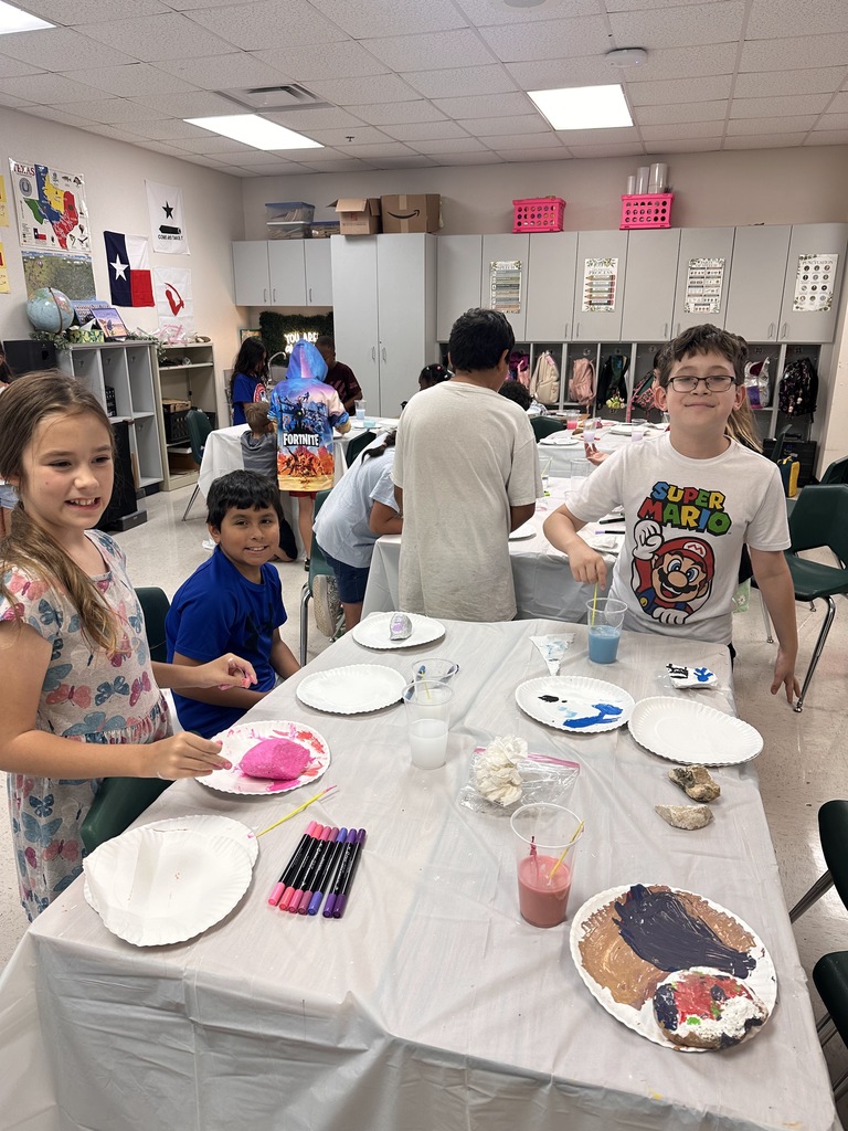Wildcats working on a rock painting project for the courtyard.