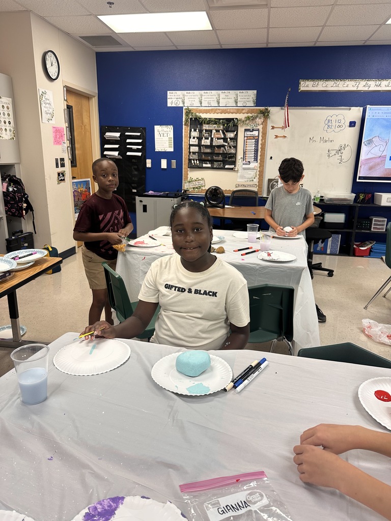 Wildcats working on a rock painting project for the courtyard.