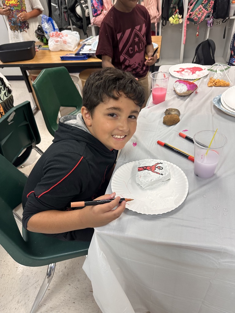 Wildcats working on a rock painting project for the courtyard.