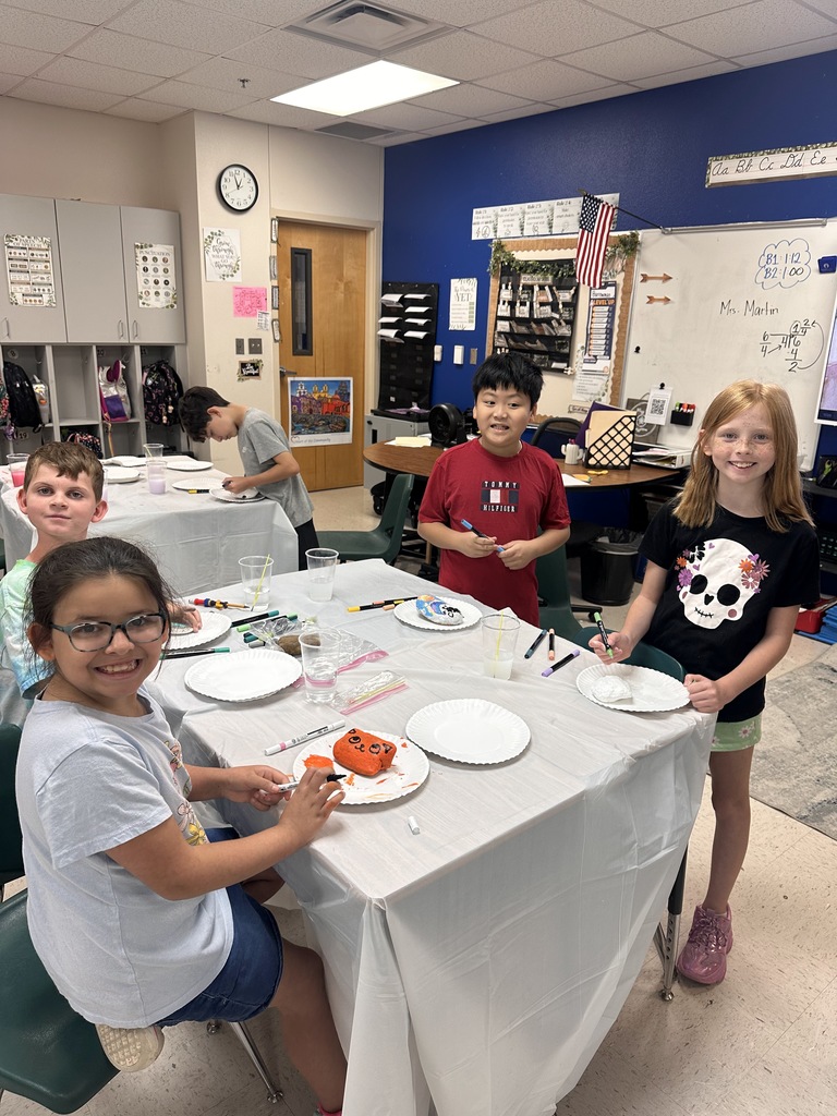 Wildcats working on a rock painting project for the courtyard.