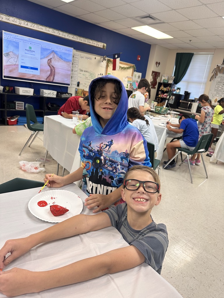 Wildcats working on a rock painting project for the courtyard.