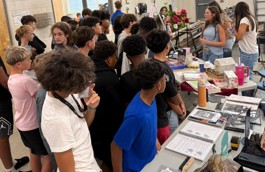 junior high students listen as a high school student explains wide-ranging career & technology education programs offered at samuel clemens high school, including floral design