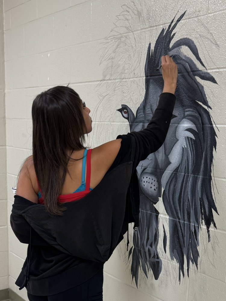 female student painting mural 