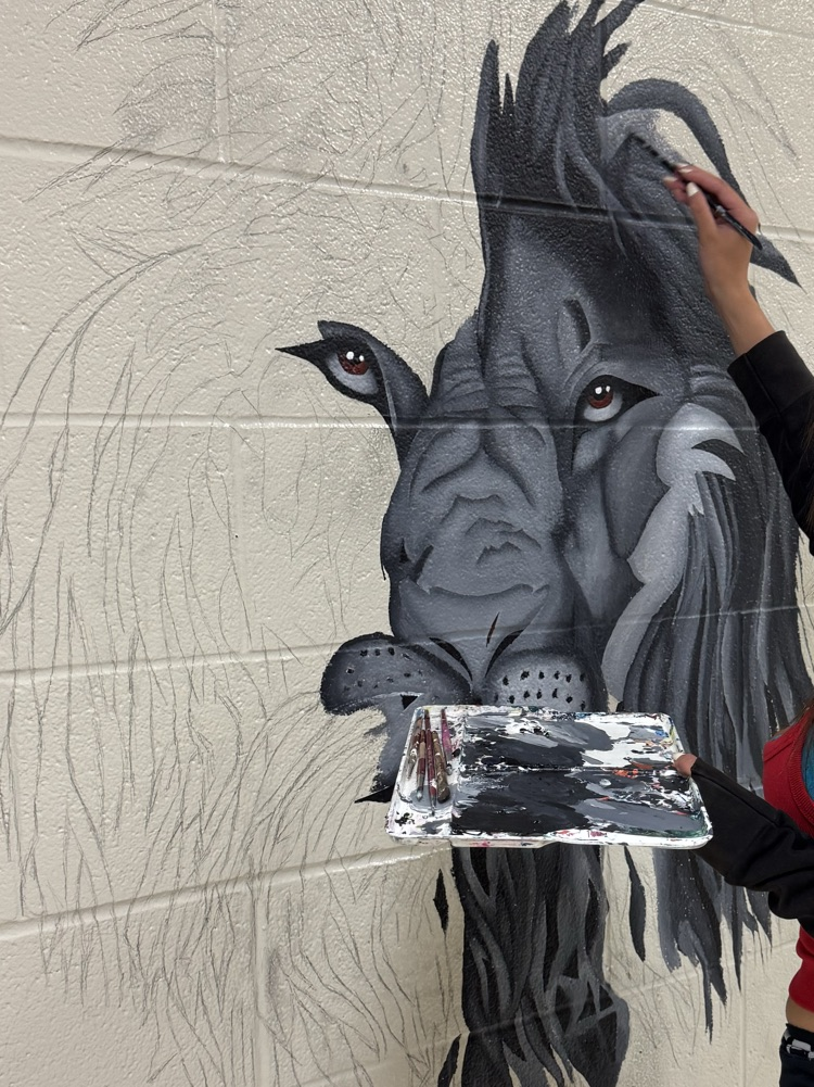 female student painting mural