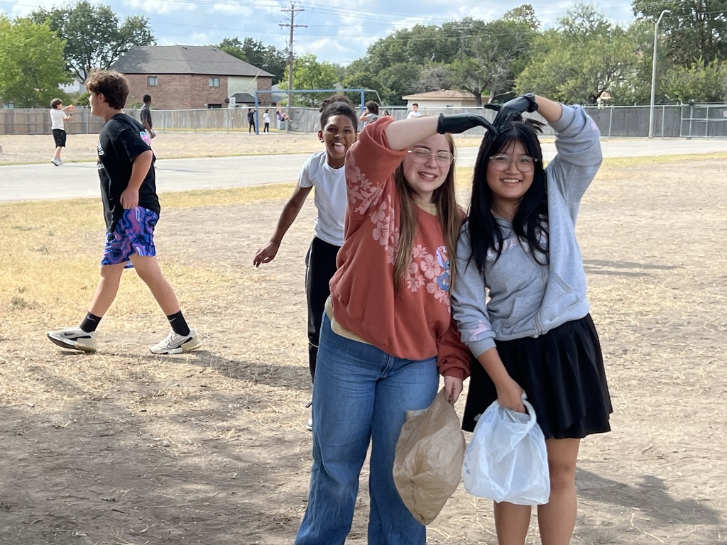 2 girls making a heart with their arms