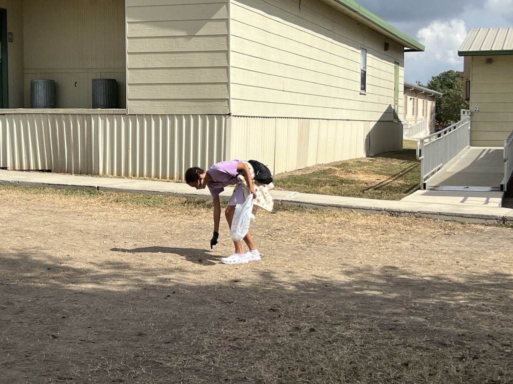6th grader picking up trash