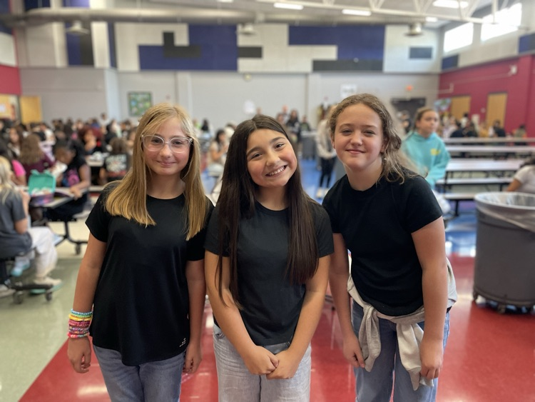 Three students posing as twins