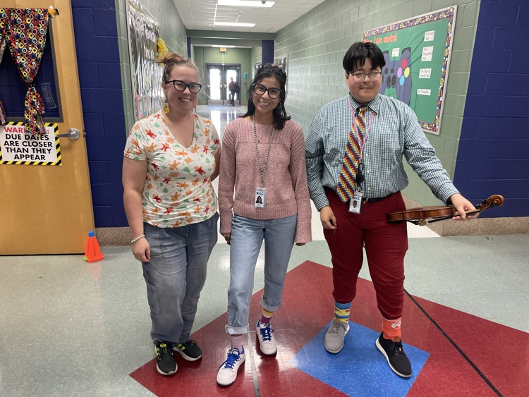 Three teachers in the hallway, dressed up wacky clothes