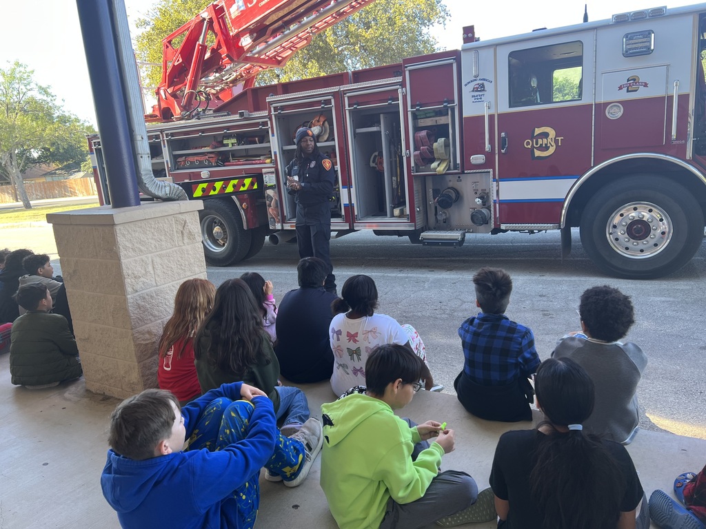 students sitting looking at a fire truck