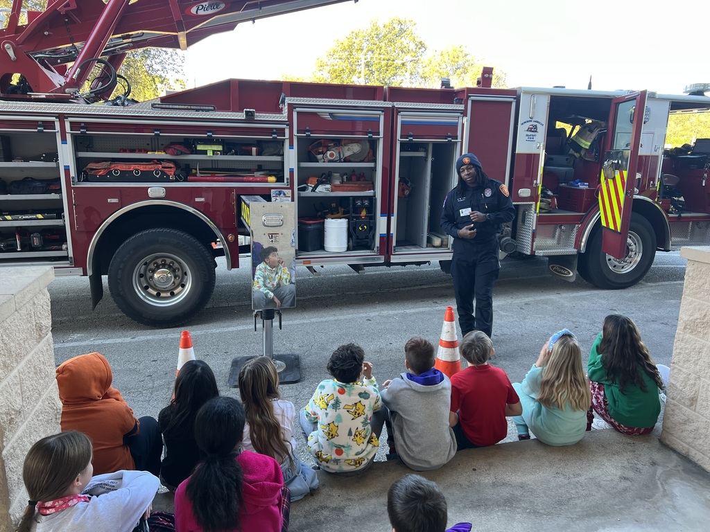 students looking at fire truck equipment