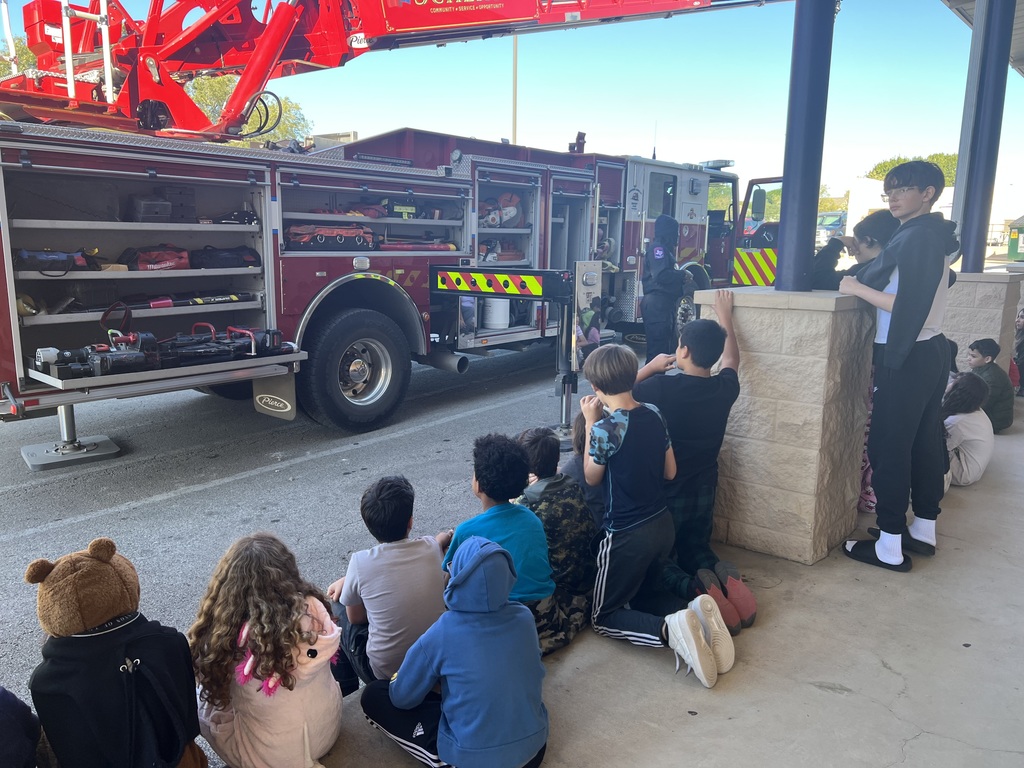 students listening to the firefighters