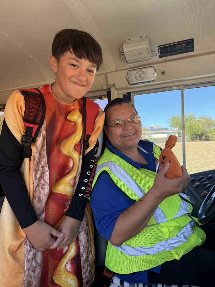 student in hot dog costume posing with Bus Driver treat bag
