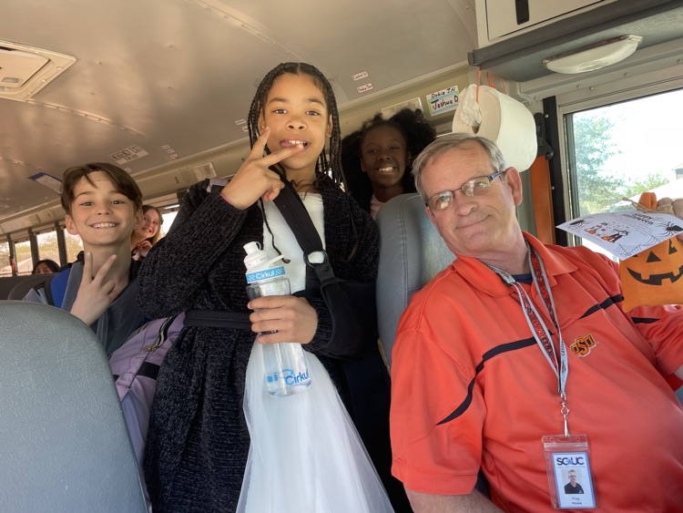 A few students posing with a Bus Driver