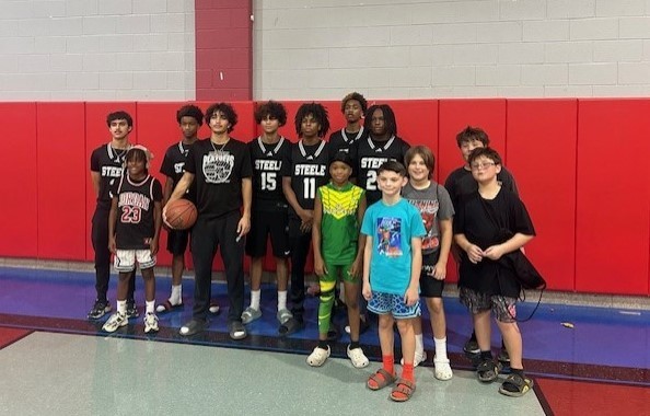 Husky students posing with the high school players