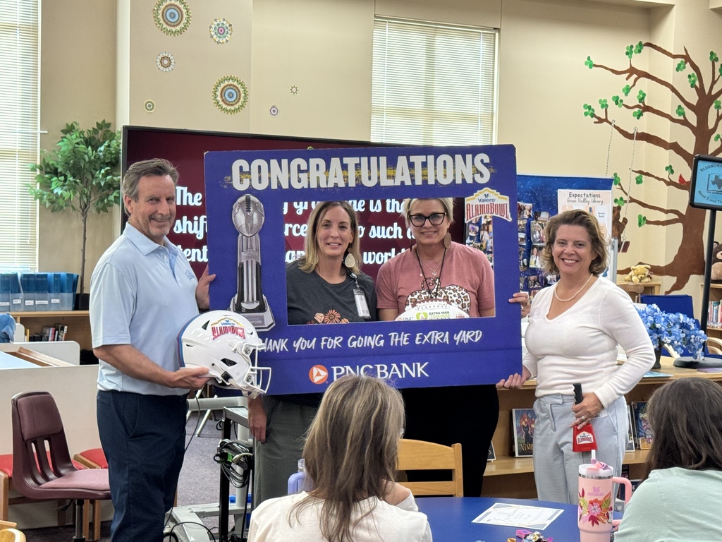 Group of teachers and guests smile after naming teacher as a grant recipient